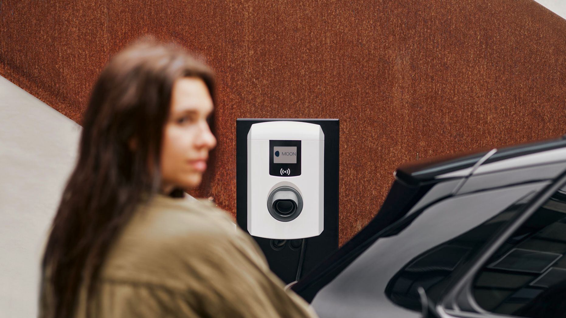 A woman puts a tap valve in a car