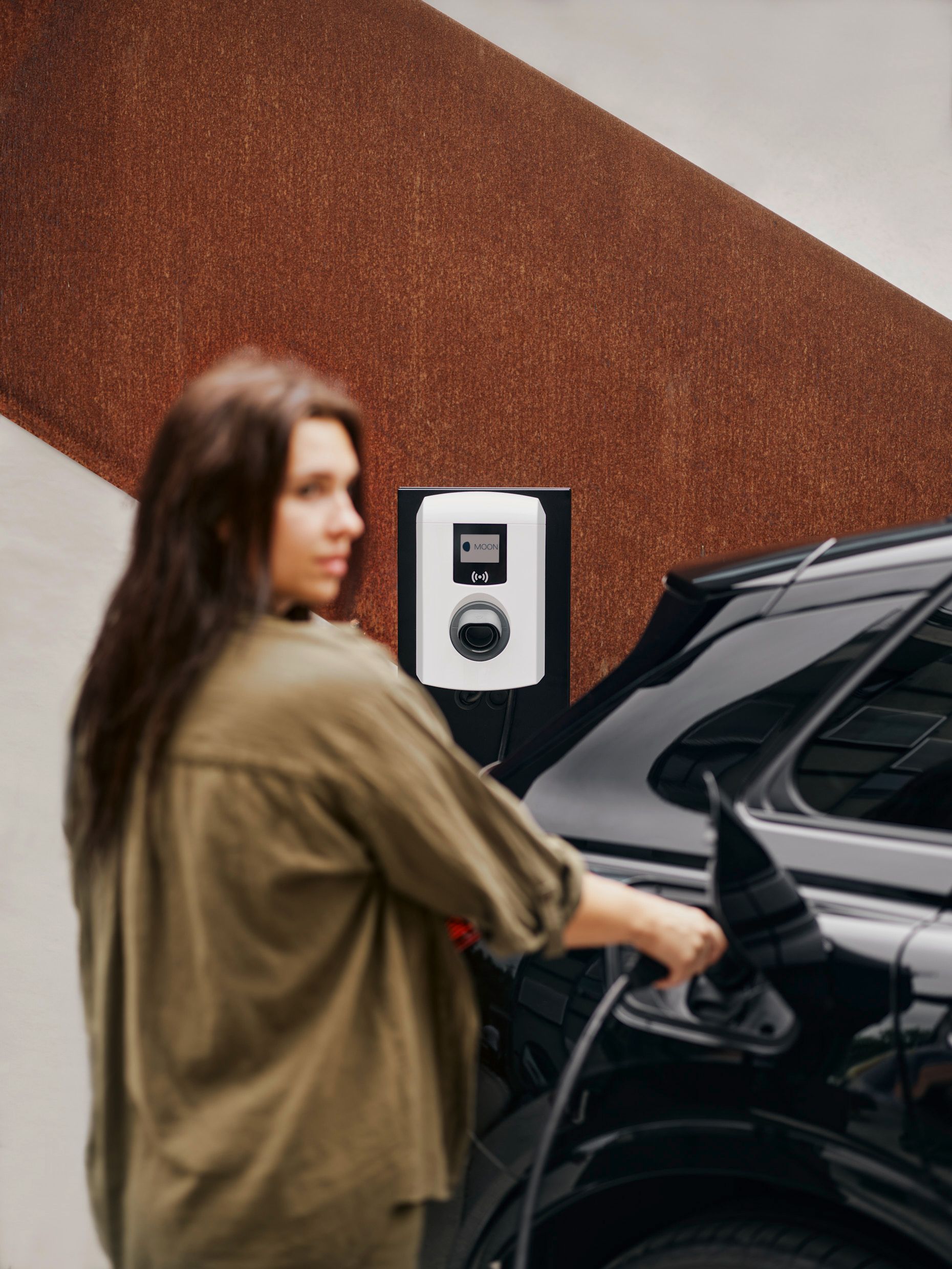 A woman puts a tap valve in a car